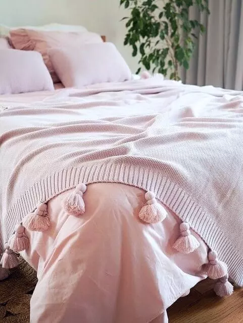 różowa narzuta na łóżko z frędzlami